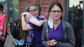 Workers at a family planning clinic watch an abortion rights march in Chicago
