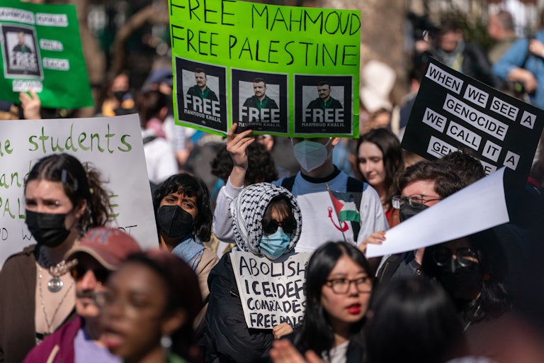 Protesters hold up signs in support of Mahmoud Khalil