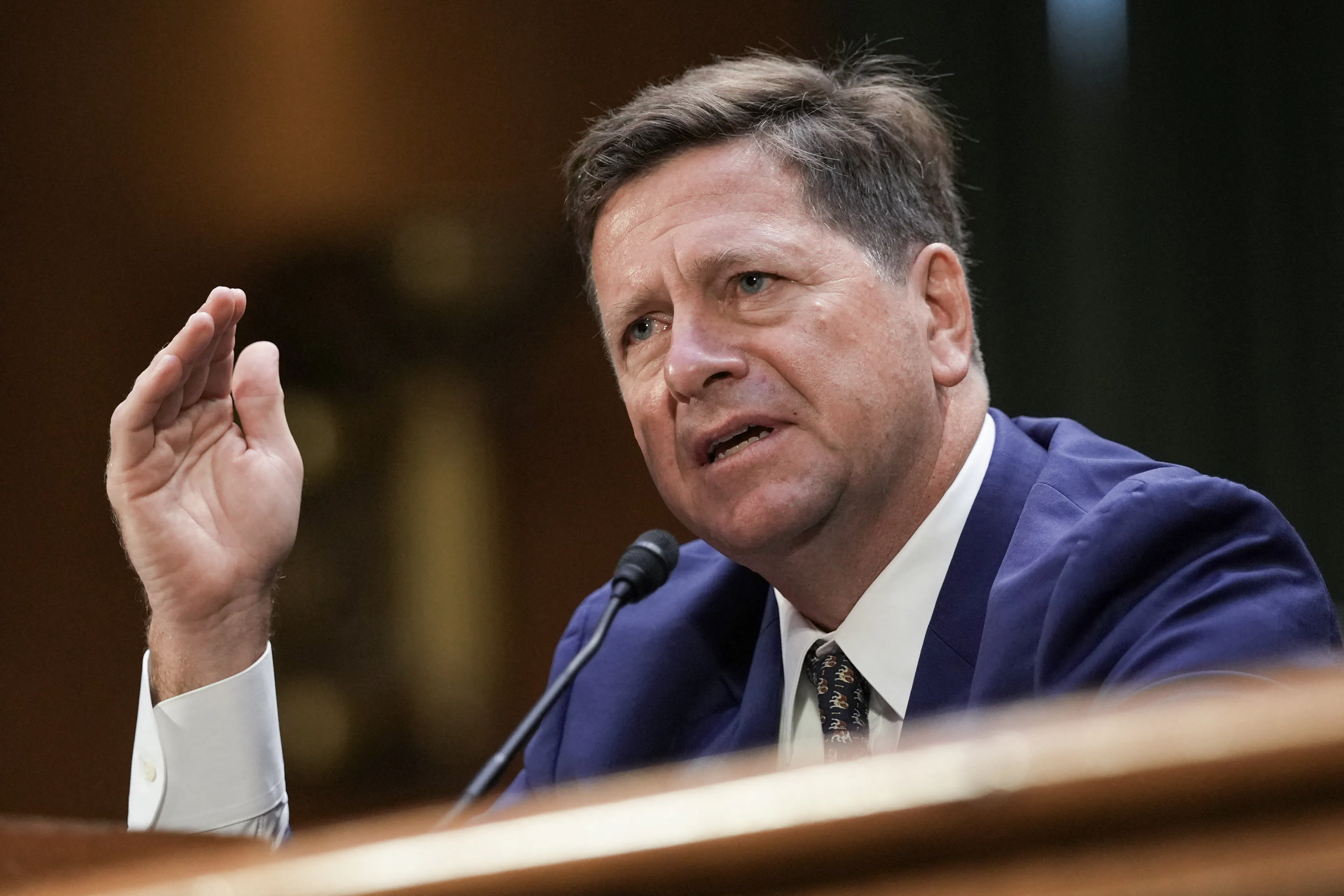 DNI nominee Jay Clayton gestures while speaking during his Senate committee confirmation hearing.