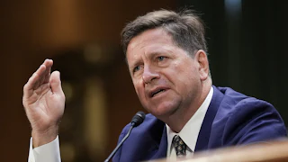 DNI nominee Jay Clayton gestures while speaking during his Senate committee confirmation hearing.
