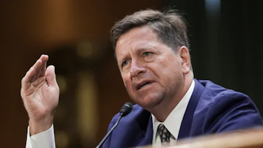 DNI nominee Jay Clayton gestures while speaking during his Senate committee confirmation hearing.