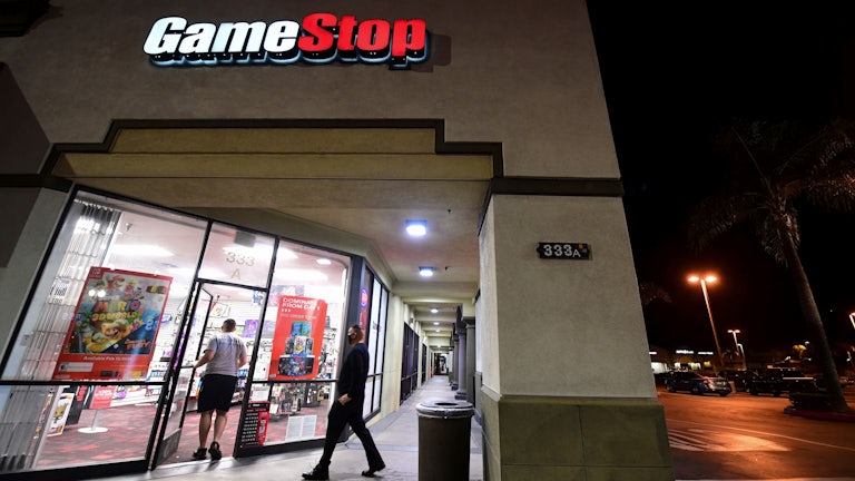 People enter a GameStop store in Alhambra, California.