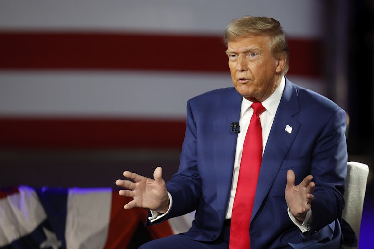 Donald Trump speaks and splays his hands outward