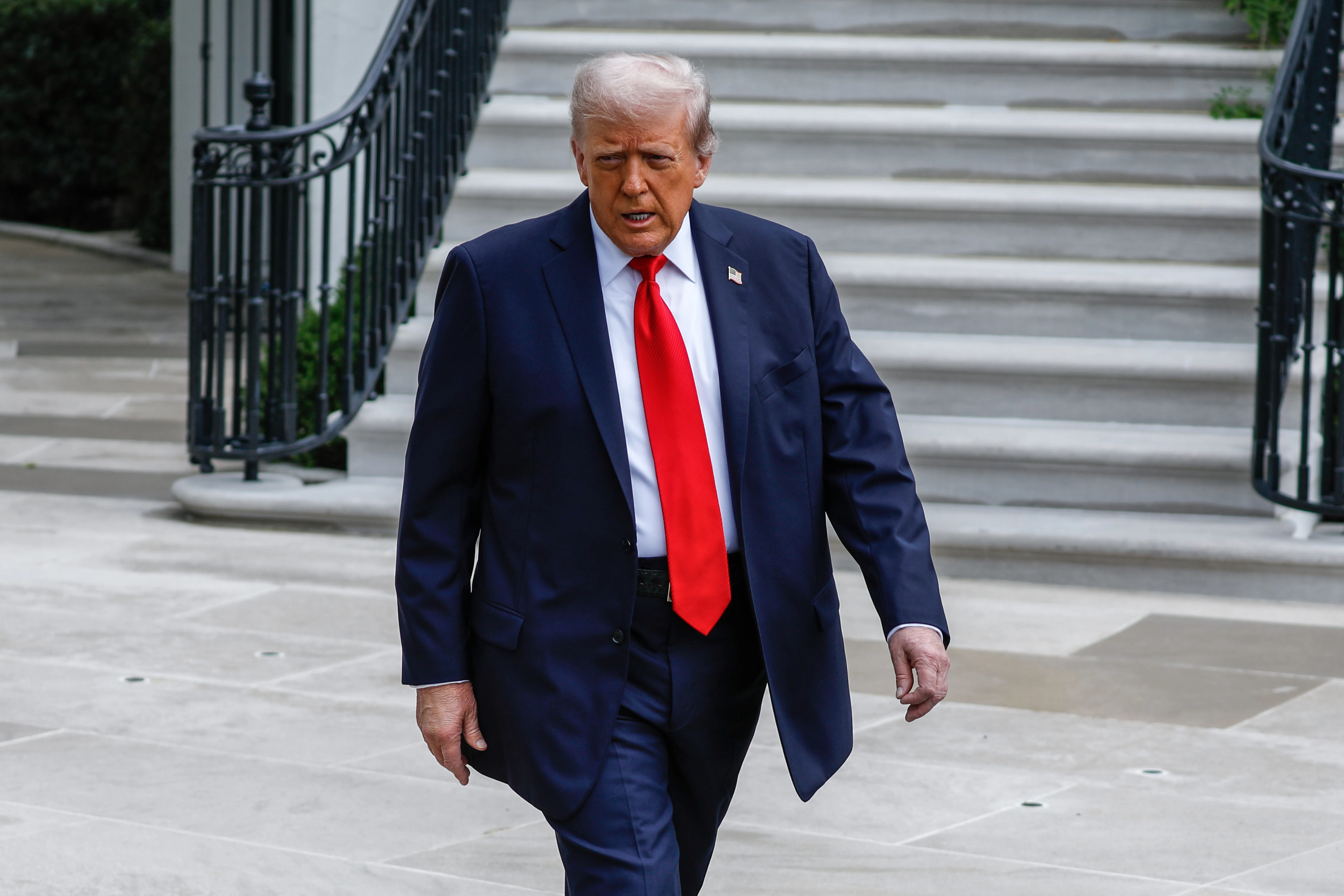 Donald Trump walking outside the White House