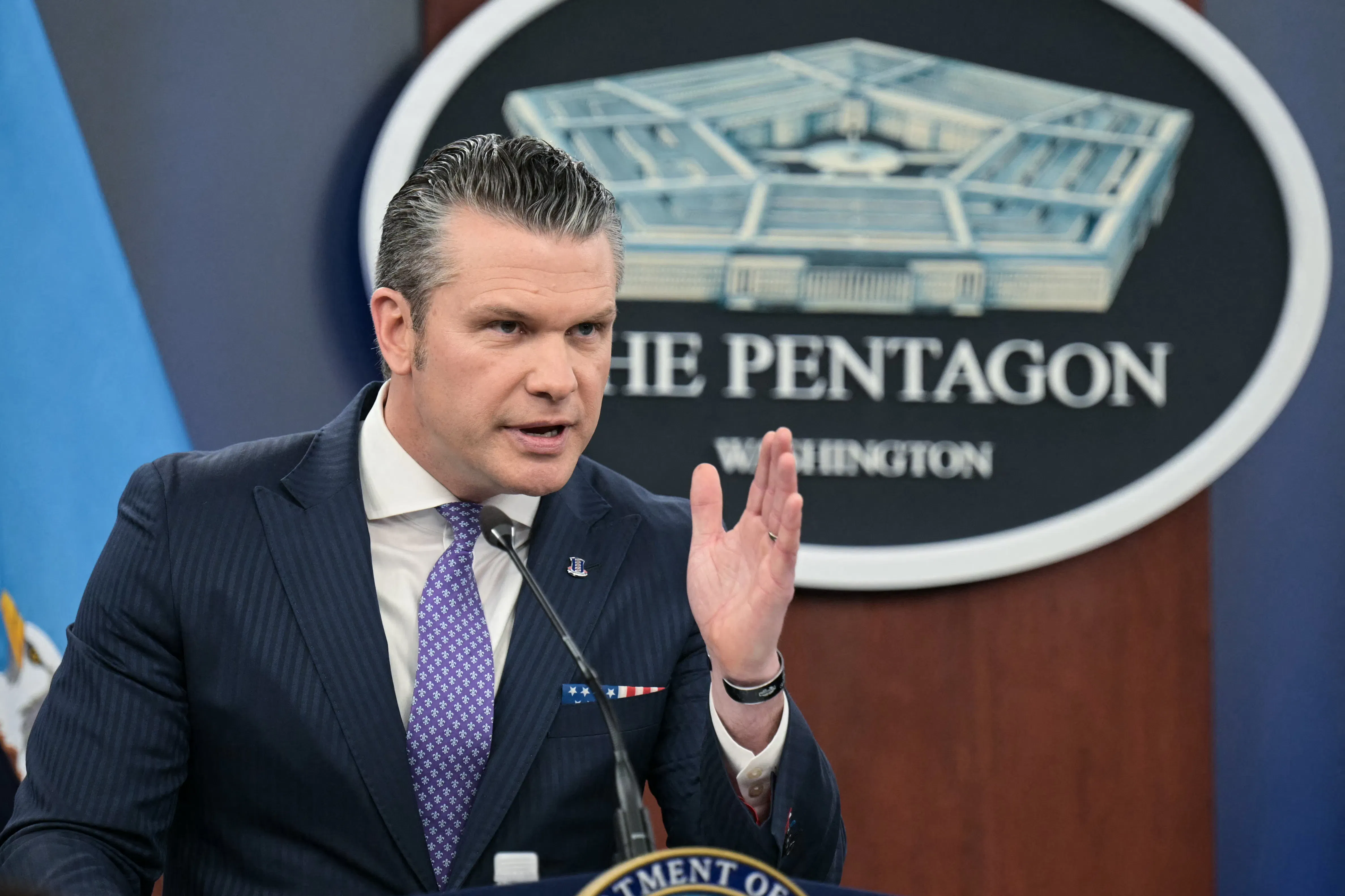 Defense Secretary Pete Hegseth speaks at a podium.