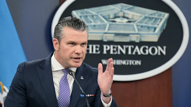 Defense Secretary Pete Hegseth speaks at a podium.