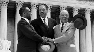 A photo from May 17, 1954 showing George E.C. Hayes, Thurgood Marshall, and James M. Nabrit joining hands after the ruling on Brown v. Board of Education that school segregation is unconstitutional.