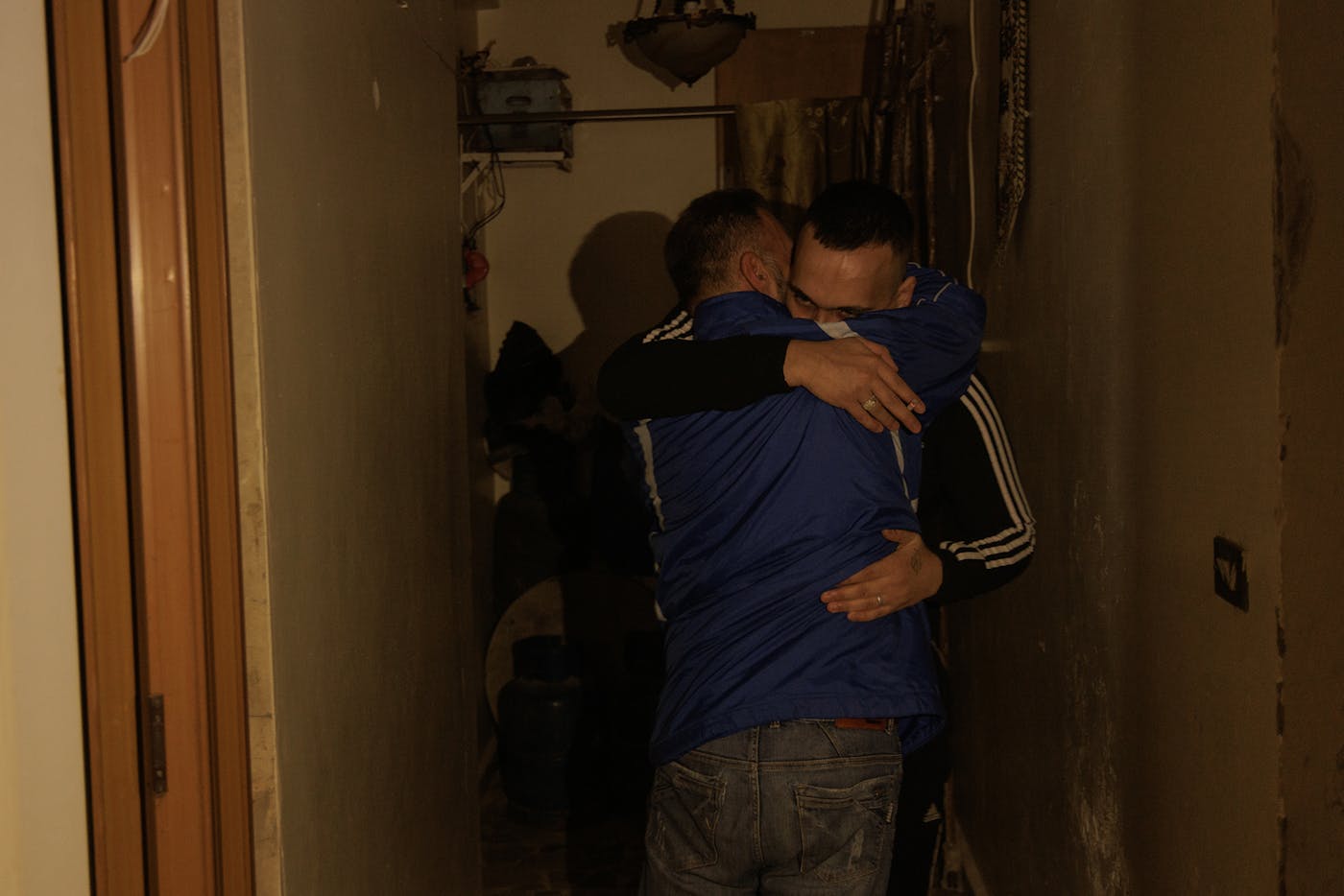 Bilal Shaheen, age 28, hugs a close friend; it's the first time they've seen each other since he returned from Sednaya Prison. 