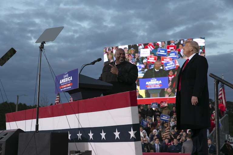 Mark Robinson and Donald Trump smile at each other while onstage at a Trump campaign event