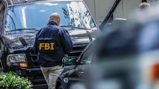 An FBI agents walks to his car.