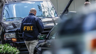 An FBI agents walks to his car.
