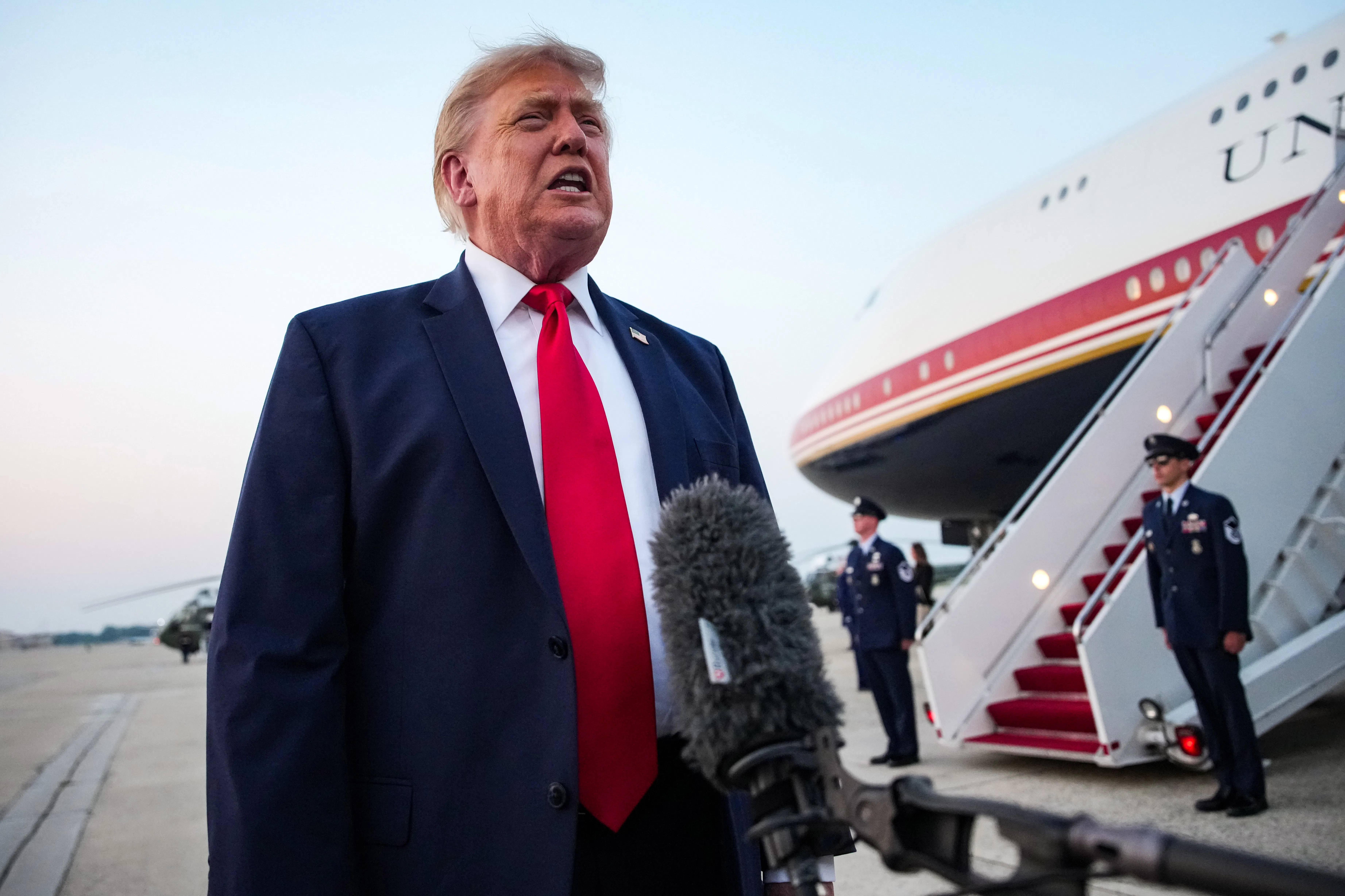 Donald Trump stands next to Air Force One.