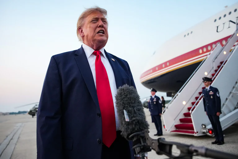 Donald Trump stands next to Air Force One.