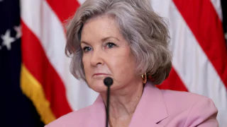 Chief of Staff Susie Wiles sits in front of a microphone during a Donald Trump event