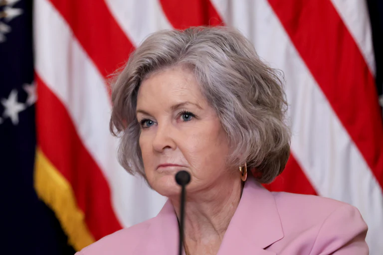 Chief of Staff Susie Wiles sits in front of a microphone during a Donald Trump event