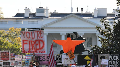 Placards decorate a fence surrounding Lafayette Square in front of the White House in Washington, D.C. on November 6, 2020