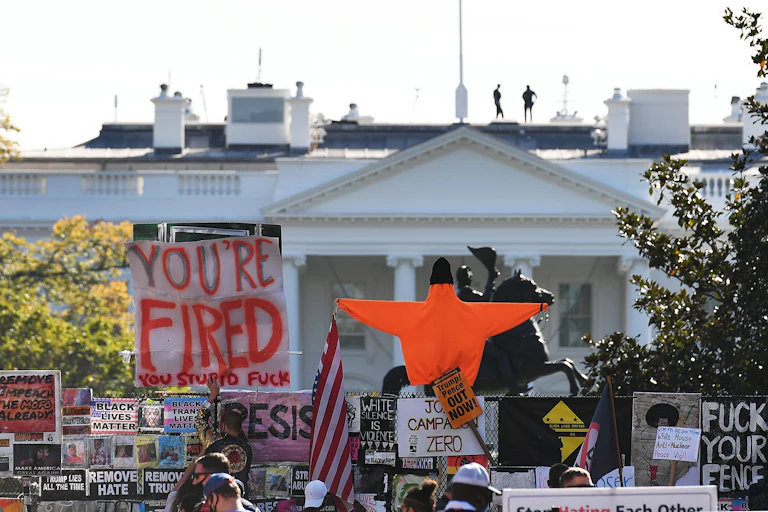 Placards decorate a fence surrounding Lafayette Square in front of the White House on November 6, 2020.