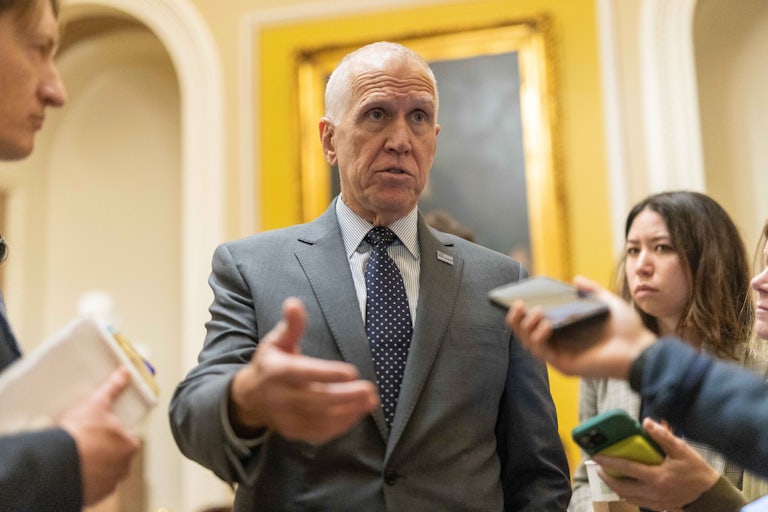 Senator Thom Tillis gestures while speaking to reporters in the Capitol