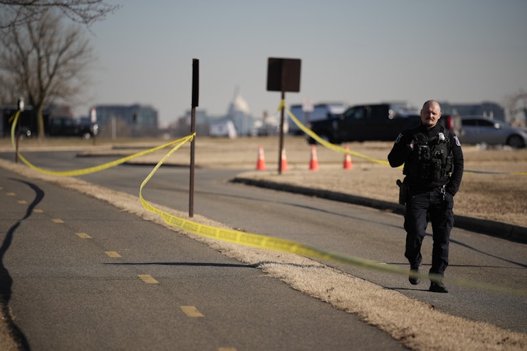 A police officer investigating the plane crash near Ronald Reagan National Airport
