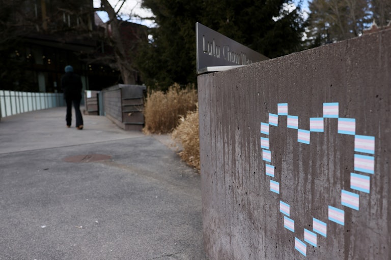 A heart made from transgender flag stickers outside
