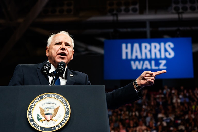 Tim Walz gestures while speaking at his first campaign rally with Kamala Harris