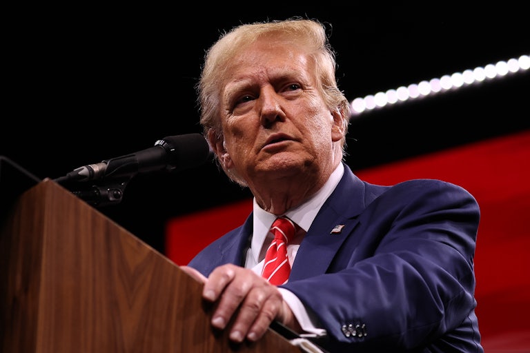 Donald Trump stands at a lectern