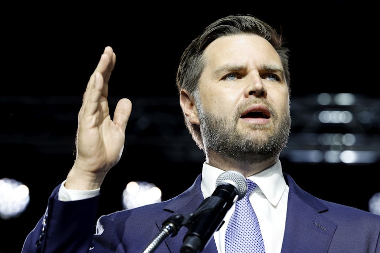 J.D. Vance speaks and raises a hand for emphasis