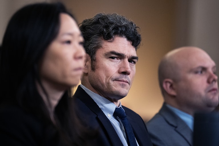 Joe Kent sits and scowls