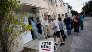 Lines of voters wait to cast their ballots.