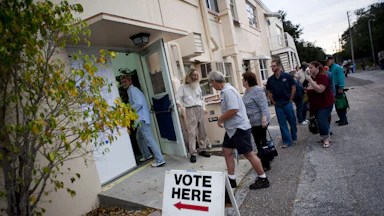Lines of voters wait to cast their ballots.