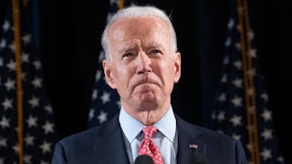 A close-up of President Joe Biden, grimacing.