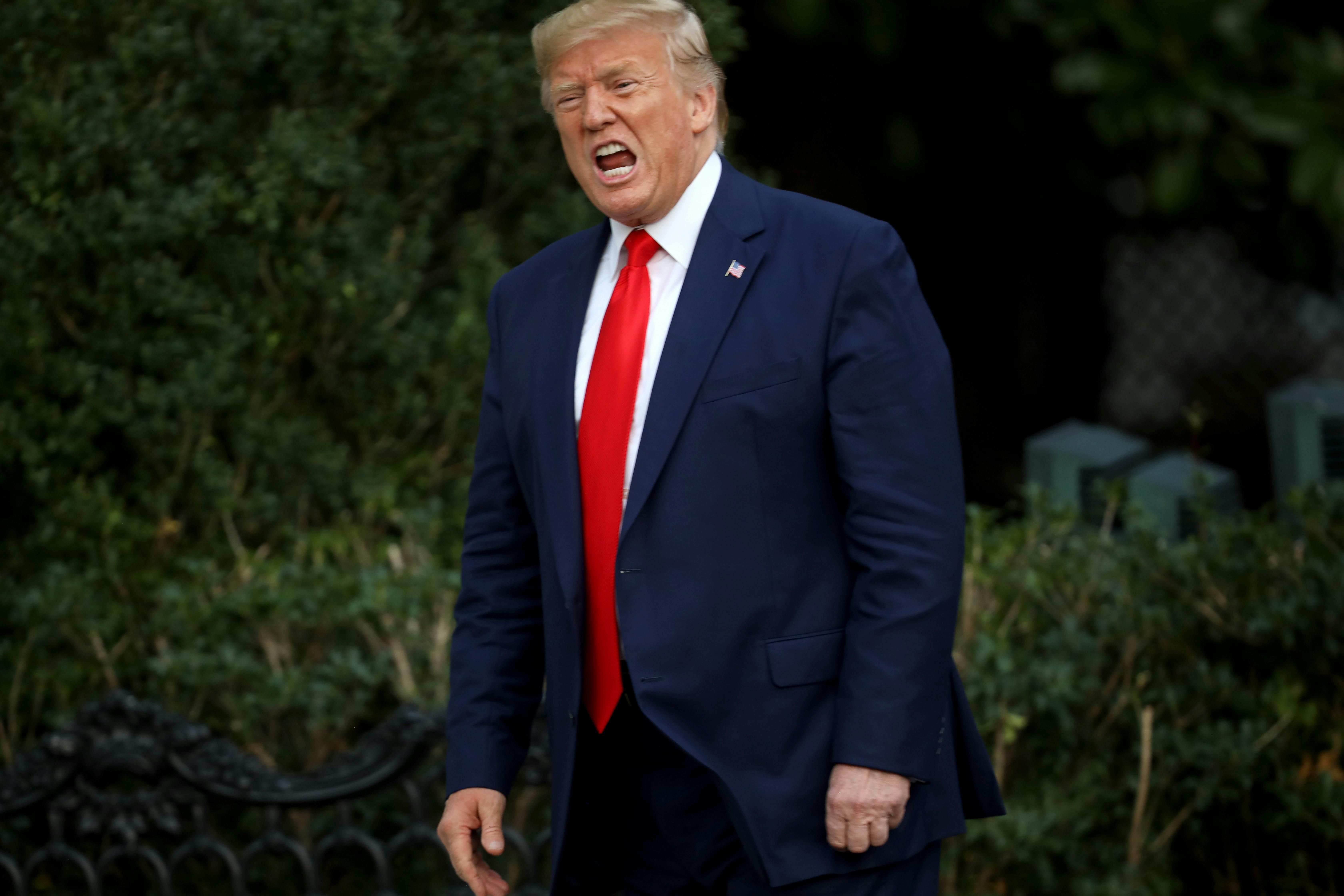 Donald Trump shouts at members of the media.