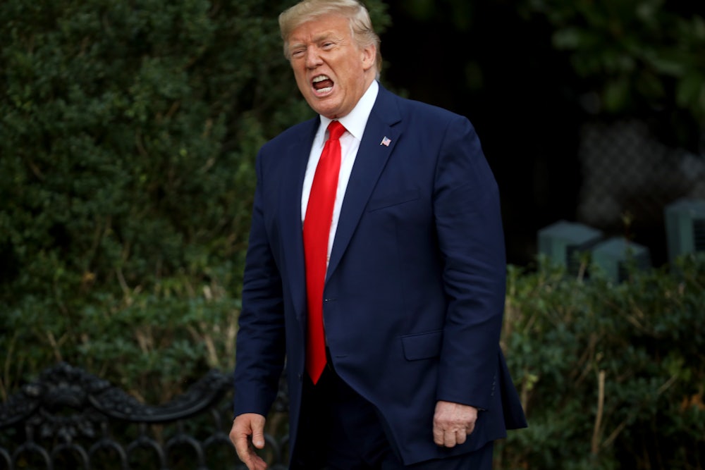 Donald Trump shouts at members of the media.