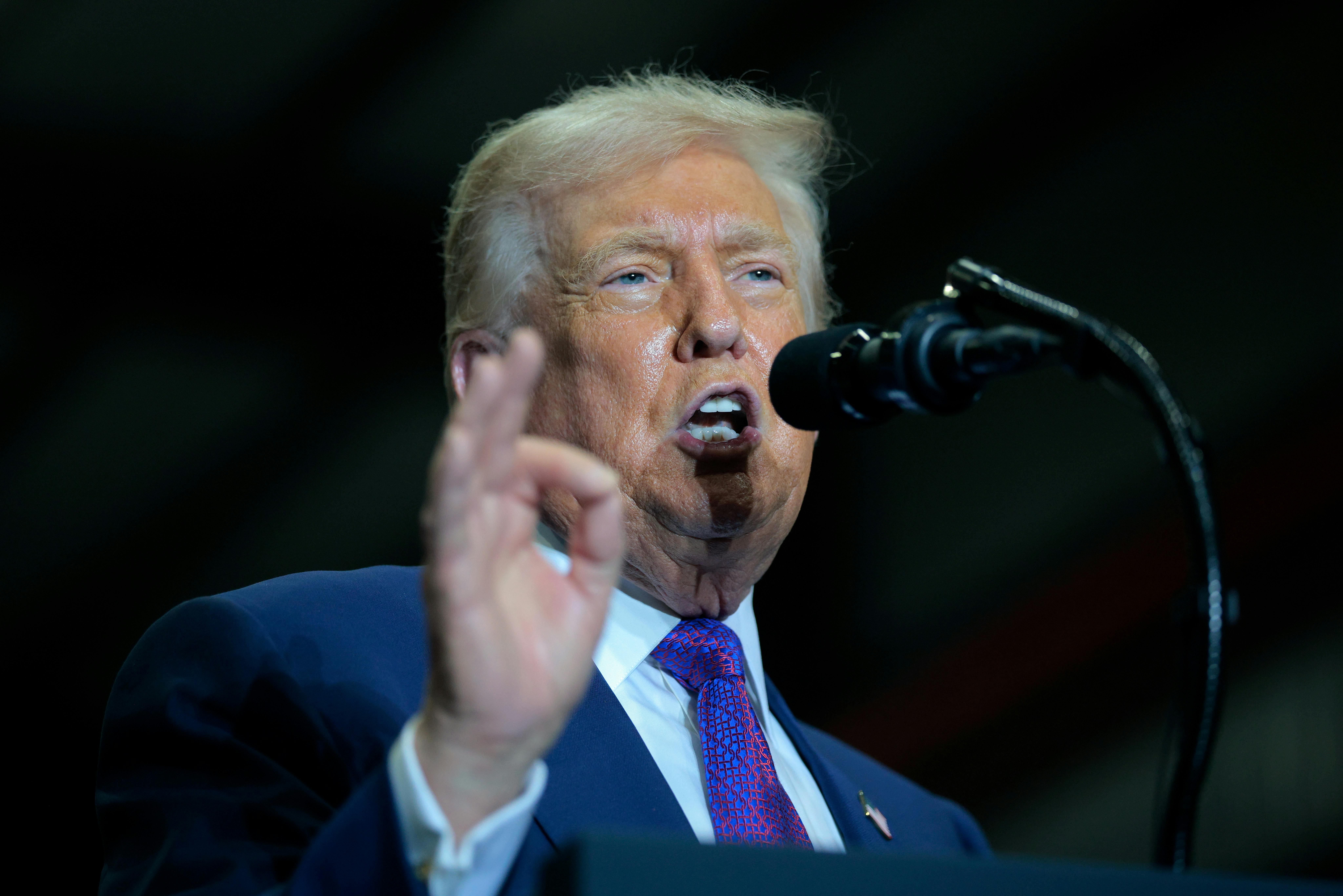 Donald Trump speaks at a podium