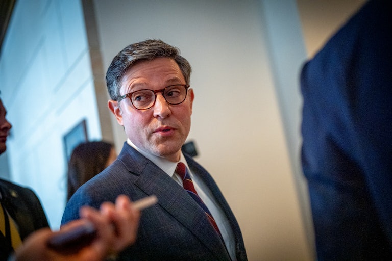 Mike Johnson speaks while looking over his shoulder