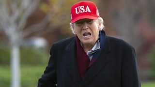 Donald Trump yells wearing a red USA hat