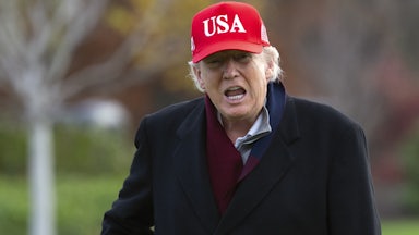 Donald Trump yells wearing a red USA hat