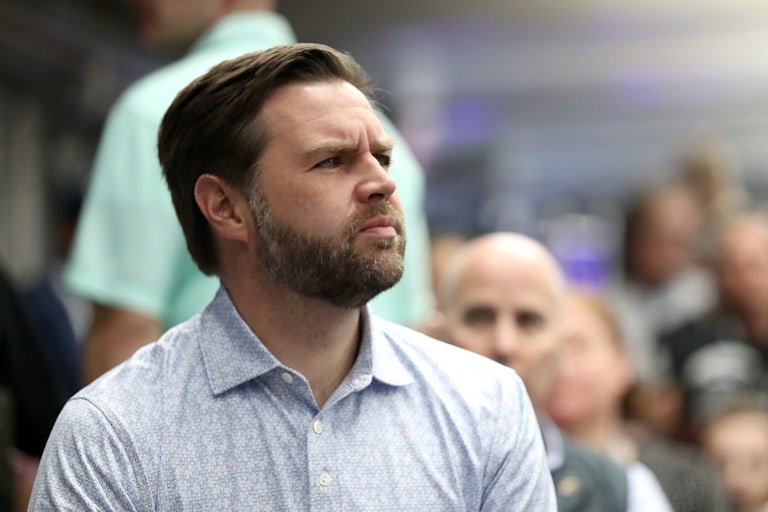 JD Vance is seen in profile as he looks up