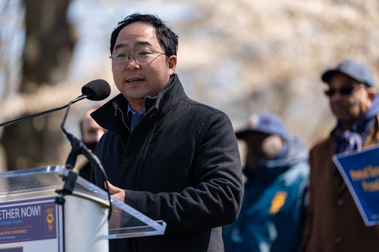 New Jersey Representative Andy Kim speaks at a lecturn outside