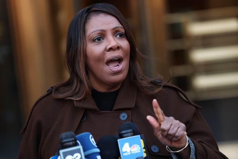 New York Attorney General Letitia James speaks at a lectern with reporters' microphones.