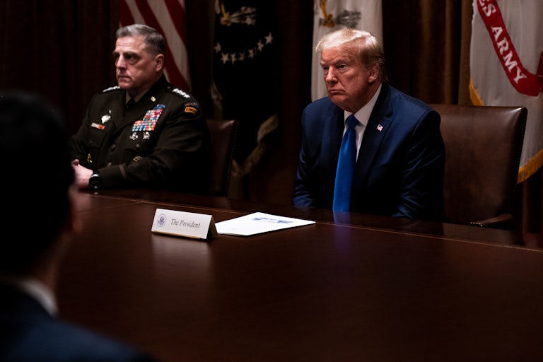 Mark Milley and Donald Trump sit next to each other