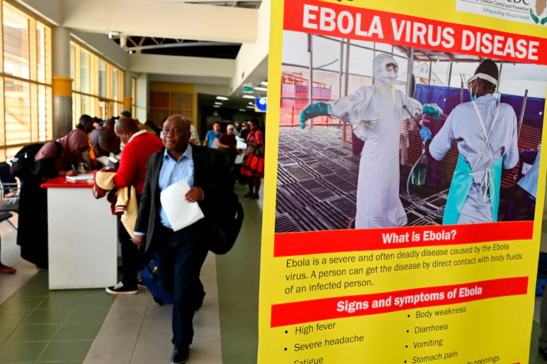 Travelers at Jommo Kenyatta International airport pass a health screening for ebola