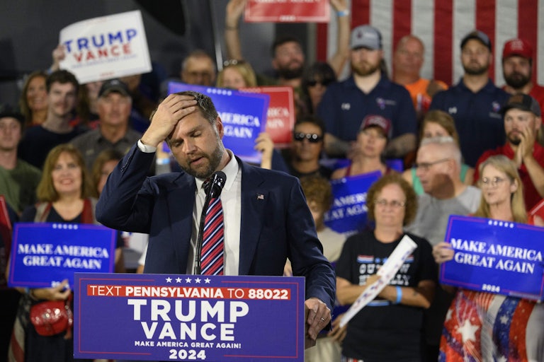 J.D. Vance rubs his forehead on stage at a Donald Trump campaign stop