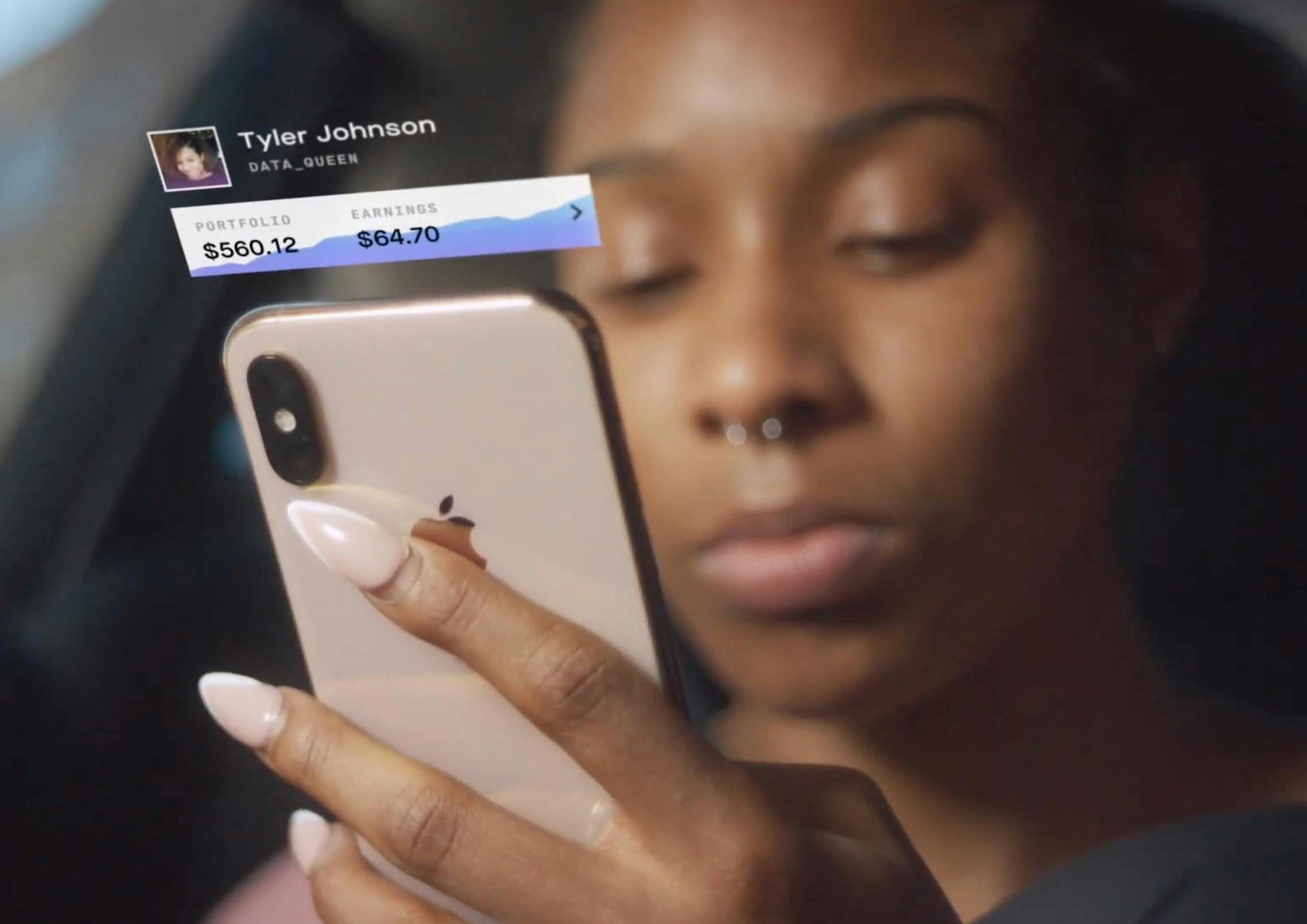 a woman looks at the Delphia app on her phone.