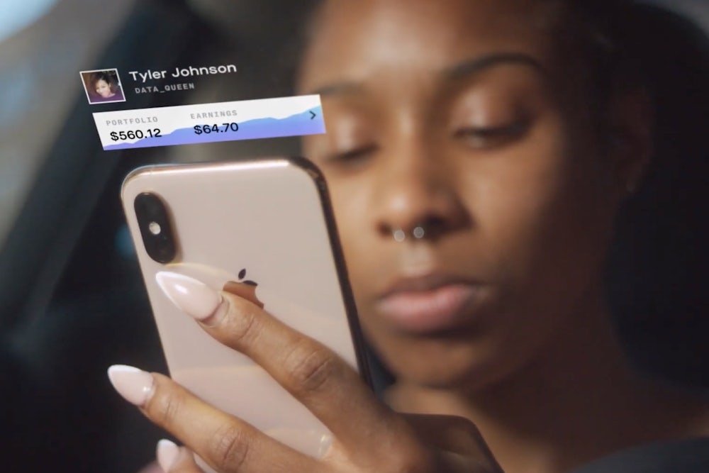 a woman looks at the Delphia app on her phone.