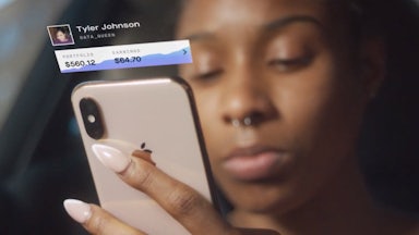 a woman looks at the Delphia app on her phone.