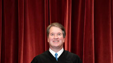 Brett Kavanaugh stands during a group photo of the Justices at the Supreme Court.