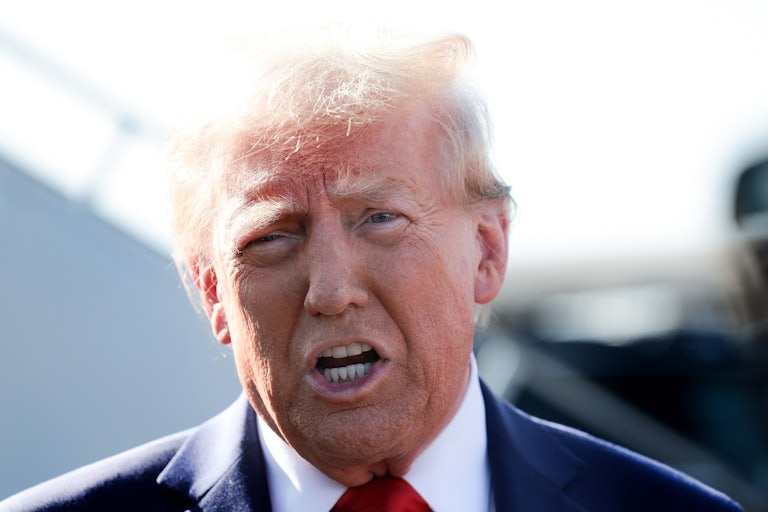 Donald Trump speaks in the sun with makeup streaked across his face.