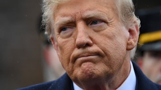 Donald Trump frowns while looking to the side.