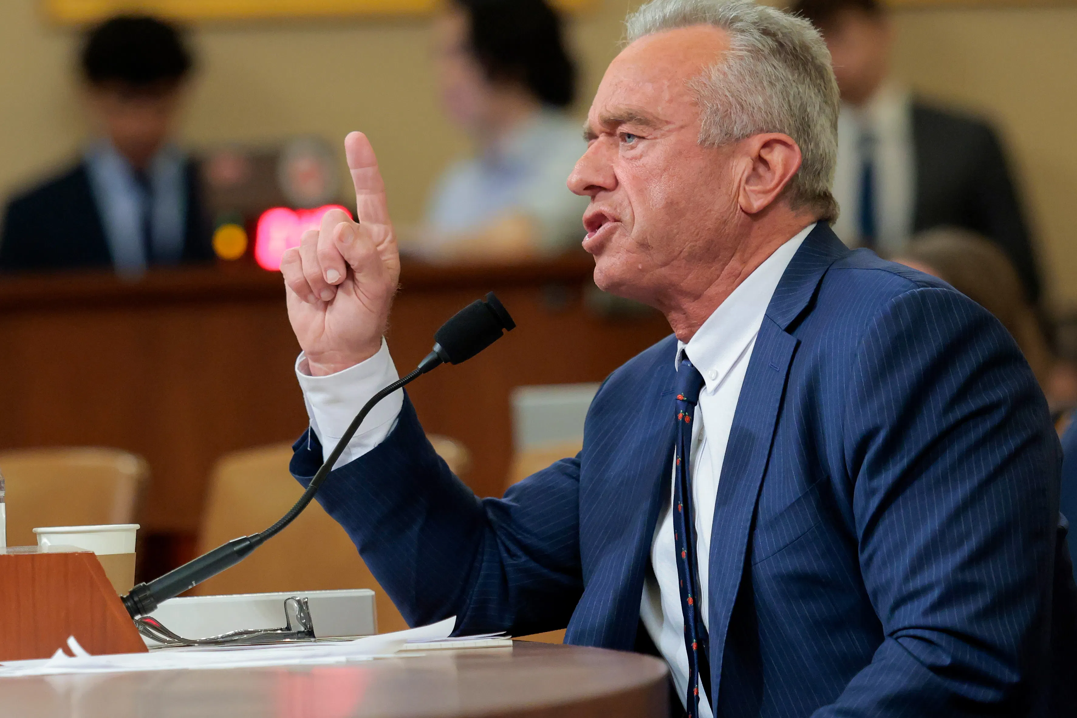 Health Secretary Robert F. Kennedy Jr. raises a finger while speaking into a microphone during a House committee hearing